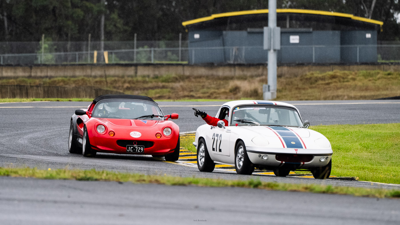 Bruce Melville 1967 Lotus Elan S3 waving past fellow Lotus driver John Culvenor in the S1 Lotus Elise.